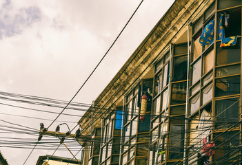 The upper part of an old house in a street of city in Thailand