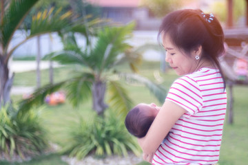 Asian Mother was carrying the baby with love
