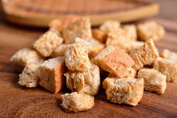 crispy croutons bread on wooden background