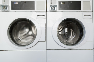 self-service laundry facilities concept - washing machines at laundromat