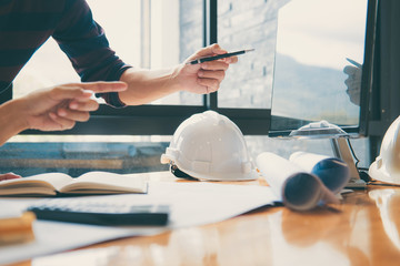 Team of Construction engineering or architect hands working on blueprint inspection in workplace,...