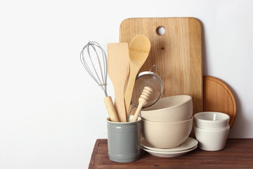 kitchenware on a wooden table on a light background. Cooking appliances.