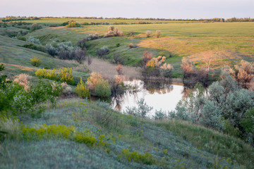 Fototapeta na wymiar View of the ravine, below which is the lake. Landscape