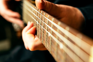 Fototapeta premium Close-up fingerboard of an electric guitar in the hands of a musician.