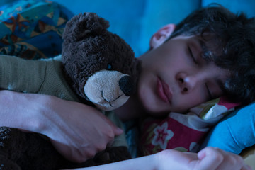 young guy in bed sleeping and hug teddy bear  f