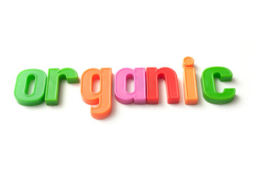 closeup of colorful plastic letters on white background - organic