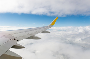 Fototapeta na wymiar Airplane wing view from window beautiful sky.