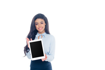 beautiful african american girl holding digital tablet with black screen and smiling at camera isolated on white