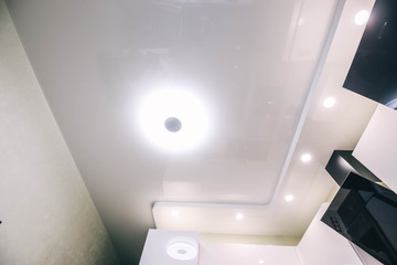  LED lighting modern kitchen. Suspended glossy ceiling.