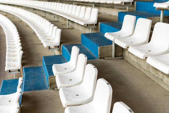 White Stadium Seats With Stairs. Soccer, Football Or Baseball Stadium Tribune Without Fans. End Of The Game.