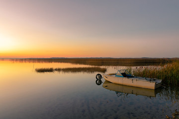 The boat on the lake in the sunsetlight. Naroch, Belarus