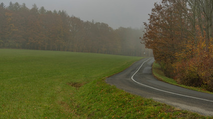 Nice asphalt road in dark misty day near Luhacovice town in Moravia