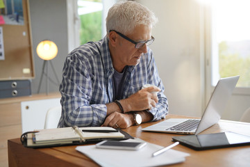 Mature man working in office