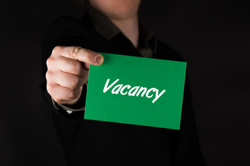 Businessman holding green card with text 