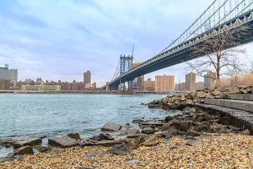 Manhattan bridge and Midtown Manhattan from Peddle beach in Brooklyn, New York, USA