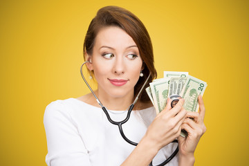 Woman with stethoscope and money bills