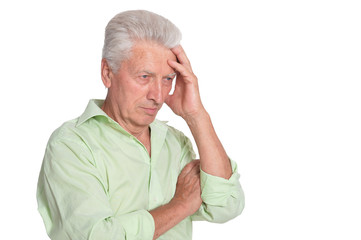 Portrait of thinking senior man on white background