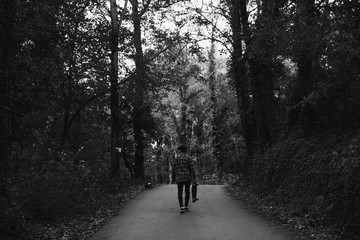 Obraz premium Man walking in the road in the autumn forest of Canada