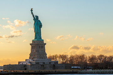 Statue of liberty horizontal during sunset in New York City, NY, USA