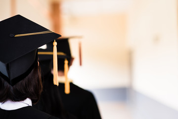 Black graduates wear black suits on graduation day at university.