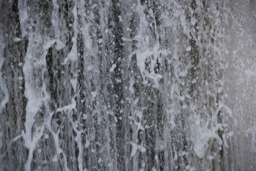 Fototapeta na wymiar Rapid flow of falling water