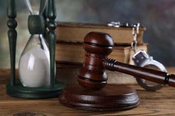 Judge gavel and statuette of justice and book background law
