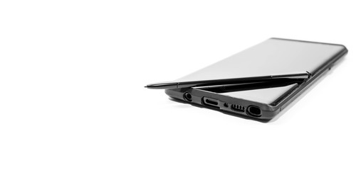 Modern mobile phone with stylus in black and white isolated on white background, space for text.