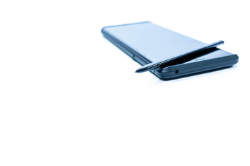 Modern mobile phone with stylus in blue tone isolated on white background, space for text.