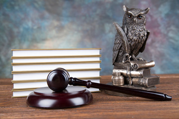 Judge gavel and statuette of justice and book background law