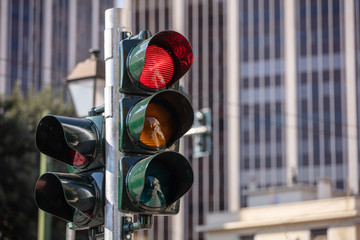 Red traffic lights for cars, office buildings background