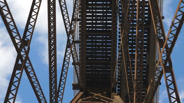 POV view underneath trestle train bridge. Drops of water falling. Toronto.
