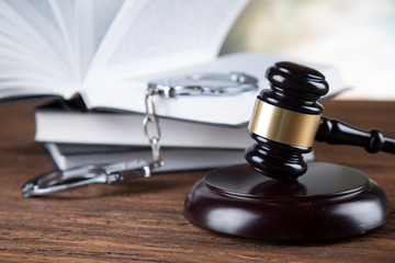 Judge gavel and statuette of justice and book background law