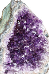 Macro Mineral Stone Amethysts in the rock on a white background