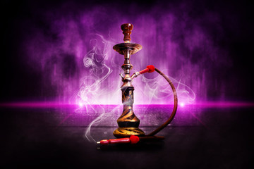 Hookah on the background of the grunge wall, neon light, rays, smoke, smog