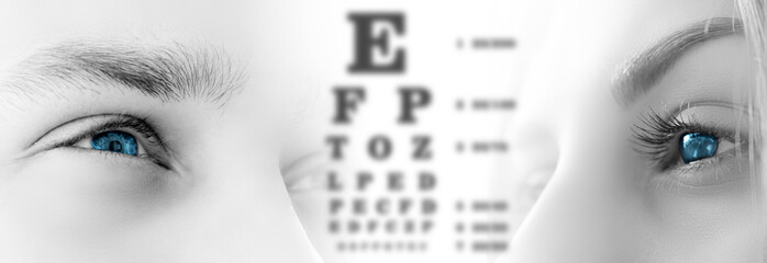 male and female eyes close up on white isolated background. Vision test table