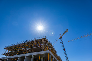 Construction site crane and sunny sky