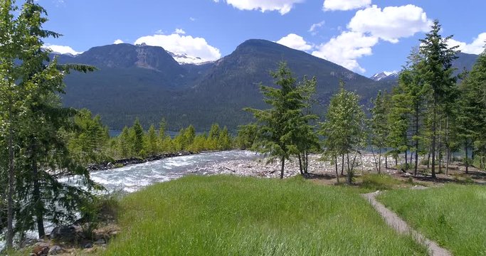 Majestic mountain river in Devis Creek, Vancouver, Canada. Drone flying. Aerial view with mountain background.