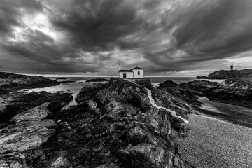Black and white sunset at Hermitage of the Virgen del Puerto in Meirás, A Coruña. Galicia, Spain.