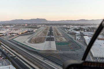 Late afternoon aerial view of airport runway approach in the San Fernando Valley area of Southern...