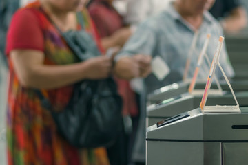Many Tourists at pedestrian access control flap barriers. Select