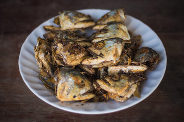 Fried fish heads for a simple meal of rural people in Thailand