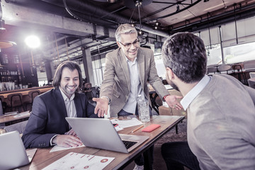 Positive delighted workers talking about modern technologies