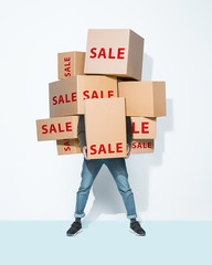 The lot of gift boxes in the hands of young man on white studio background. Cyber monday, shopping, black friday, sale, holiday, happy Christmas, sales season start concept