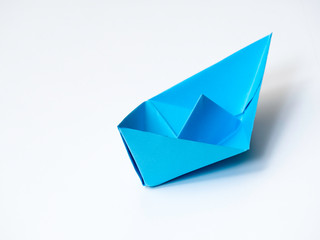 Single Blue paper boat on white