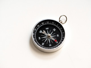 Silver compass on white