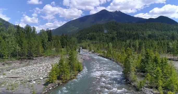 Majestic mountain river in Devis Creek, Vancouver, Canada. Drone flying. Aerial view with mountain background.