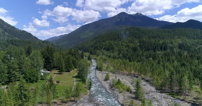 Majestic mountain river in Devis Creek, Vancouver, Canada. Drone flying. Aerial view with mountain background.