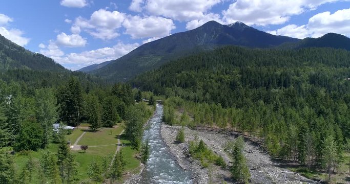 Majestic mountain river in Devis Creek, Vancouver, Canada. Drone flying. Aerial view with mountain background.