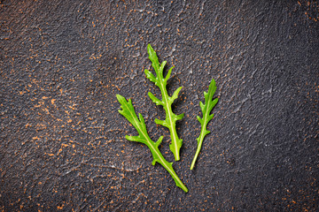 Fresh arugula leaves on rusty table