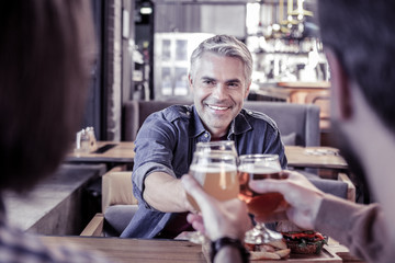 Close up of cheerful man that relaxing in pub